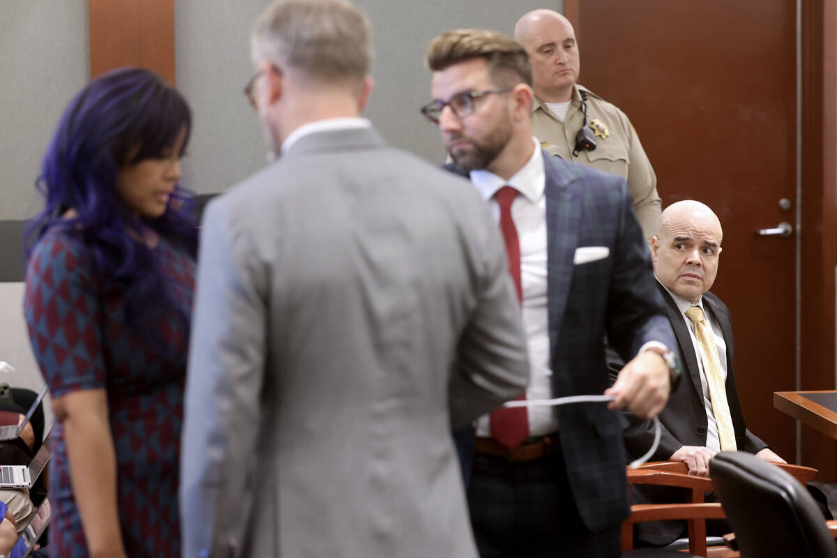 Robert Telles, right waits as his wife Mary Ann Ismael talks to his attorneys Robert Draskovich ...