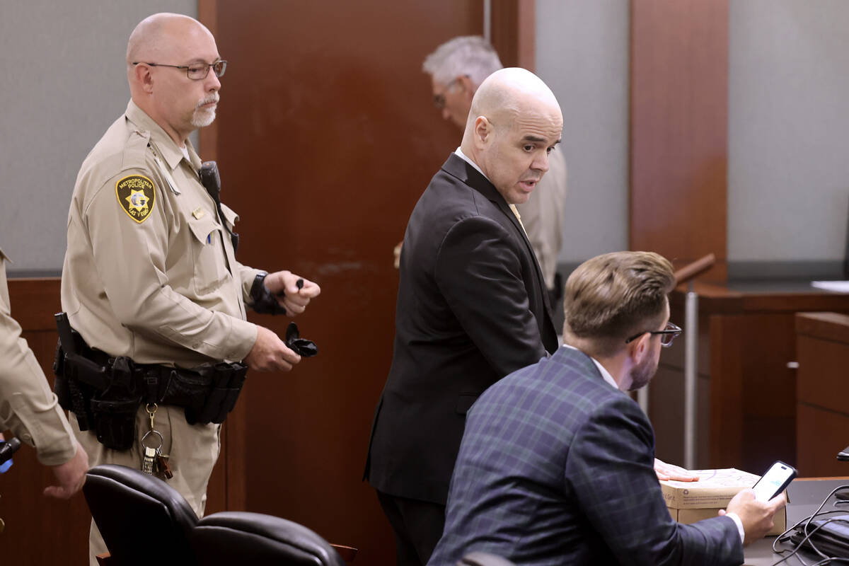 Robert Telles speaks to his attorneys before being removed removed from the courtroom after the ...