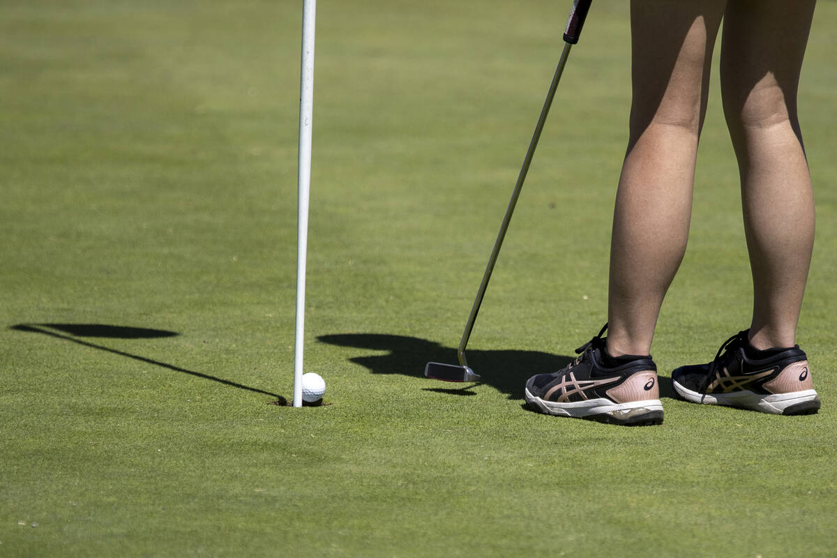 Clark’s Audrey Lac putts her ball into the hole during the Class 5A Mountain League girl ...