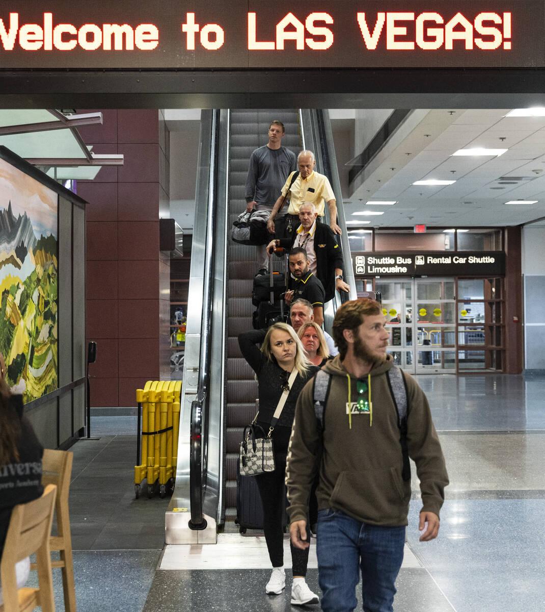 Arriving passengers head to baggage claim area at Terminal 1 of Harry Reid International Airpor ...