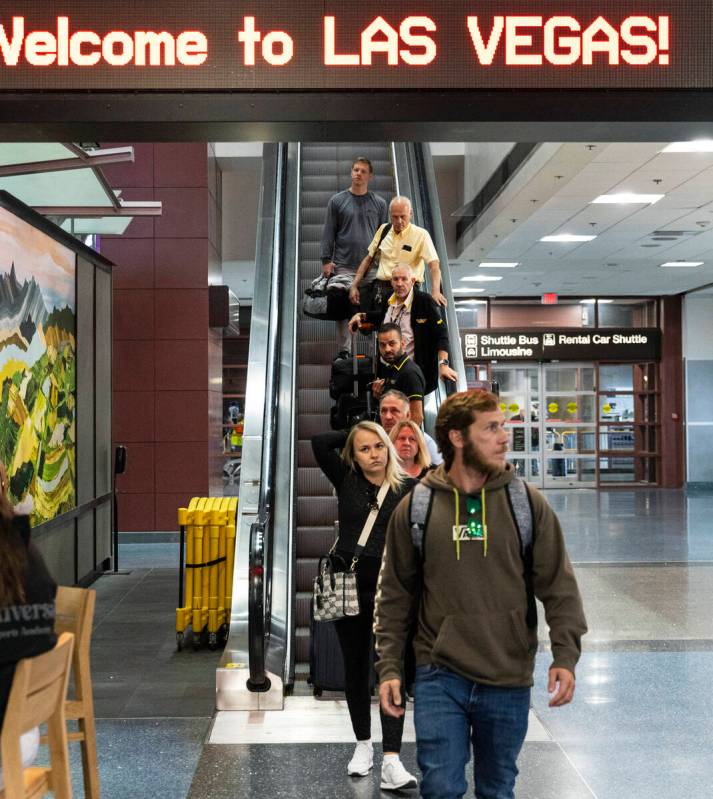 Arriving passengers head to baggage claim area at Terminal 1 of Harry Reid International Airpor ...