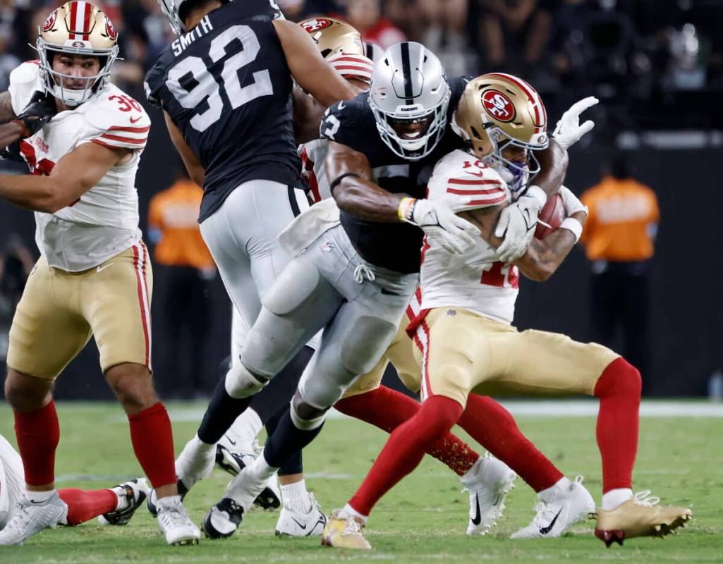 Raiders linebacker Amari Gainer (53) takes down San Francisco 49ers wide receiver Ronnie Bell ( ...