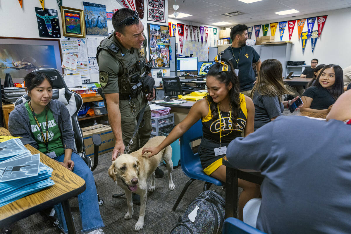 Clark County School District K-9 officer Steven Patty with his working dog Peppermint stop and ...