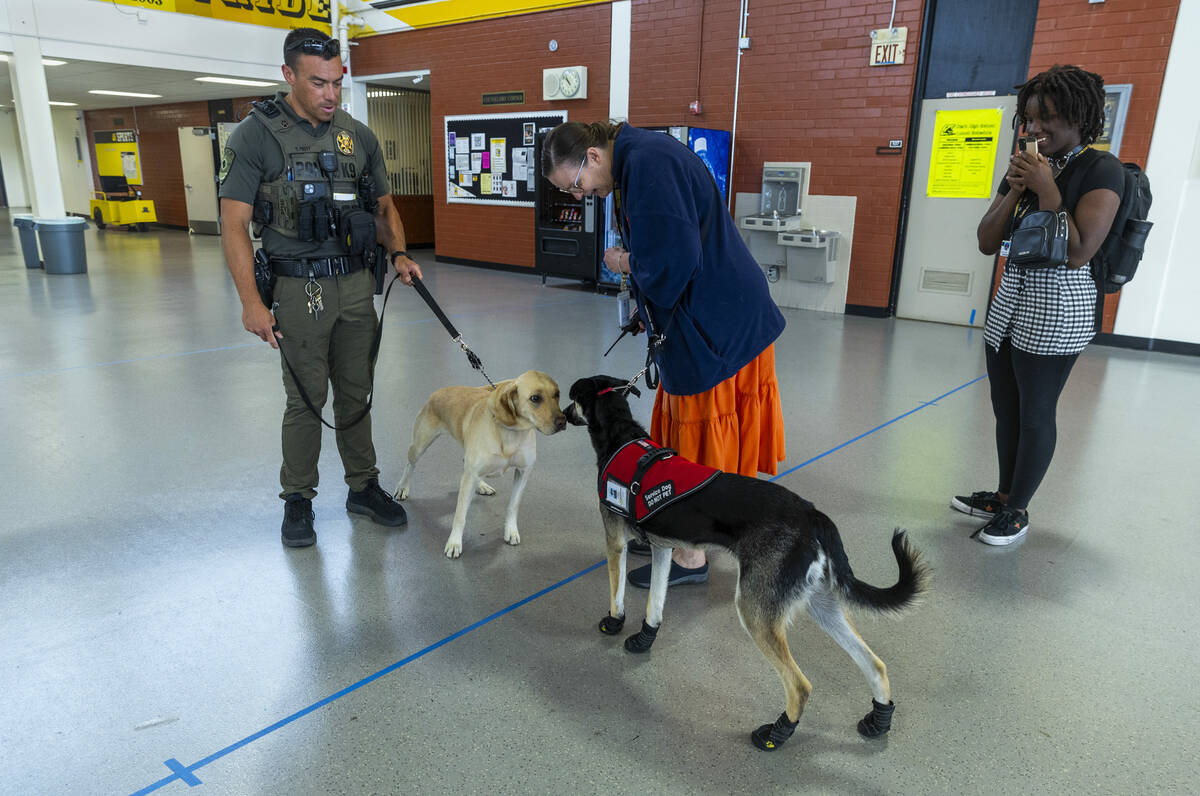 Clark County School District K-9 officer Steven Patty with his working dog Peppermint take a mo ...