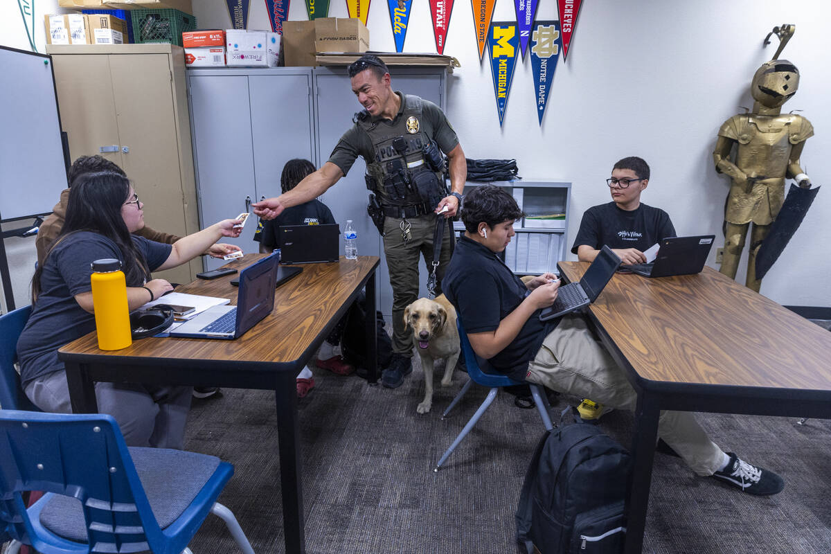 Clark County School District K-9 Officer Steven Patty with his working dog Peppermint pass out ...