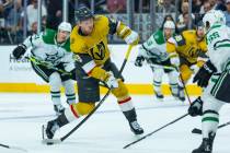 Golden Knights center Jack Eichel (9) winds up for a shot on goal past Dallas Stars defenseman ...