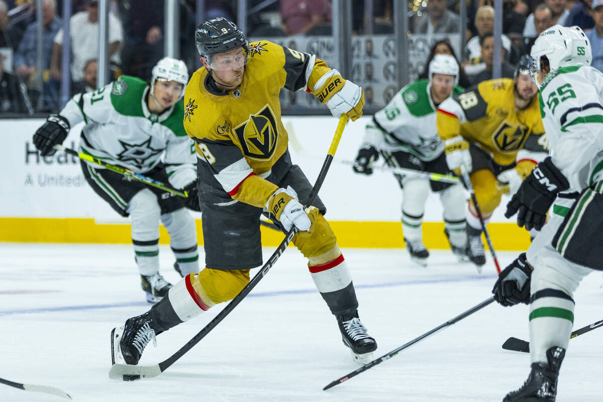 Golden Knights center Jack Eichel (9) winds up for a shot on goal past Dallas Stars defenseman ...