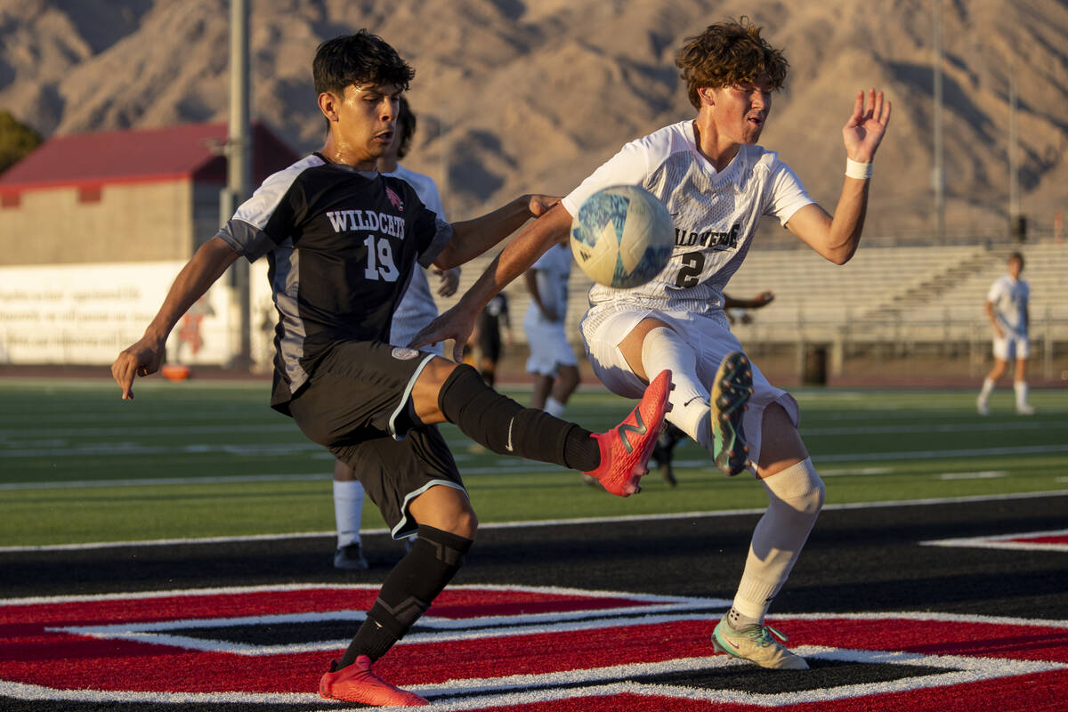 Las Vegas High junior Lex Madrigal (19) and Palo Verde senior Jaxon Law (2) compete for the bal ...