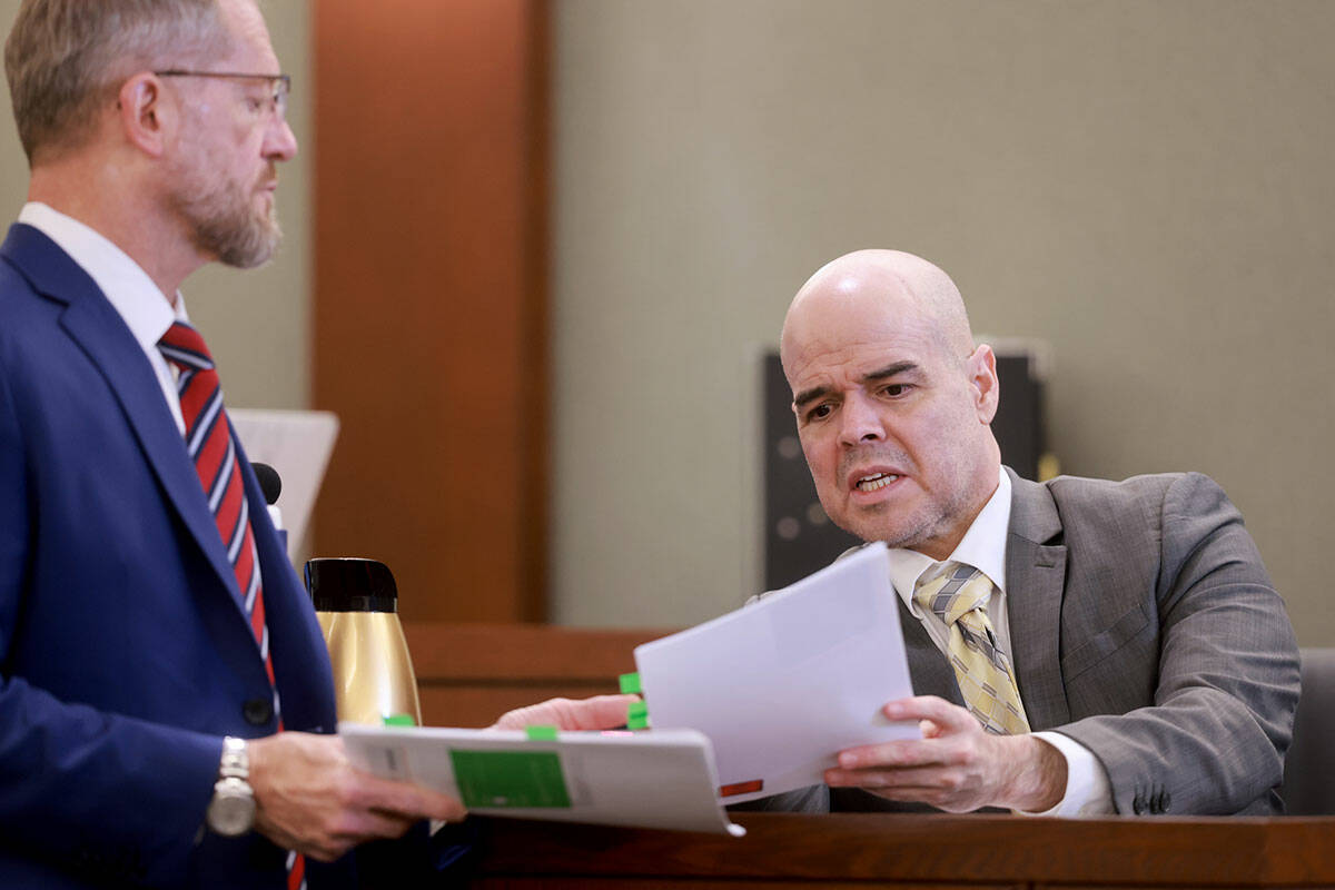 Robert Telles, right, tells his attorney Robert Draskovich which piece of evidence to put on th ...