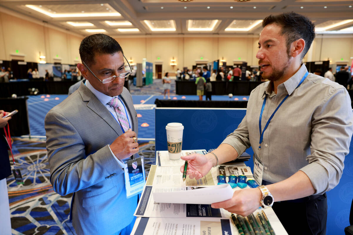 Carlos Duran with Naval Surface Warfare Center Carderock Division in Alexandria, Va., left, tal ...