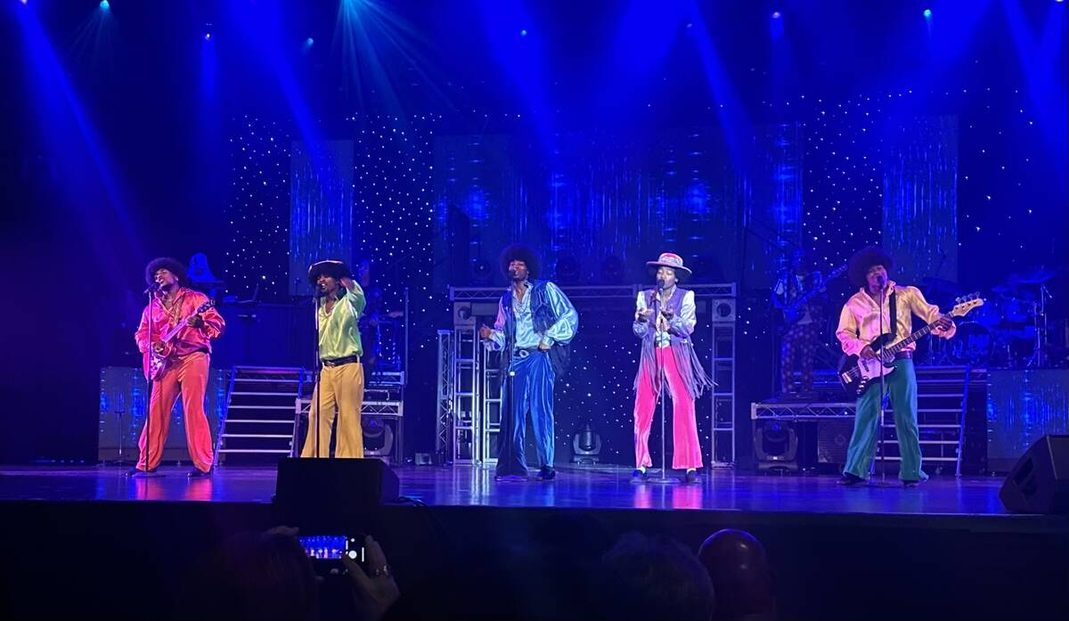 The lineup of "MJ The Evolution," performs with backing dancers Sarah Clear, left, and Ryley Cl ...