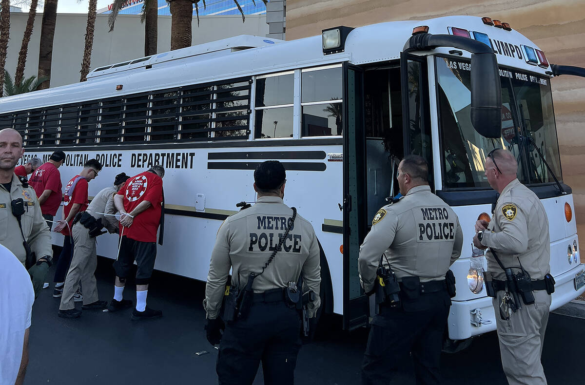 Las Vegas Metropolitan Police Department officers use zip ties as they detain about two dozen V ...