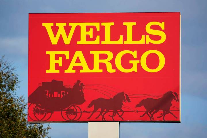 A Wells Fargo sign stands in front of a branch of the bank in Bradenton, Fla., Tuesday, Feb. 22 ...