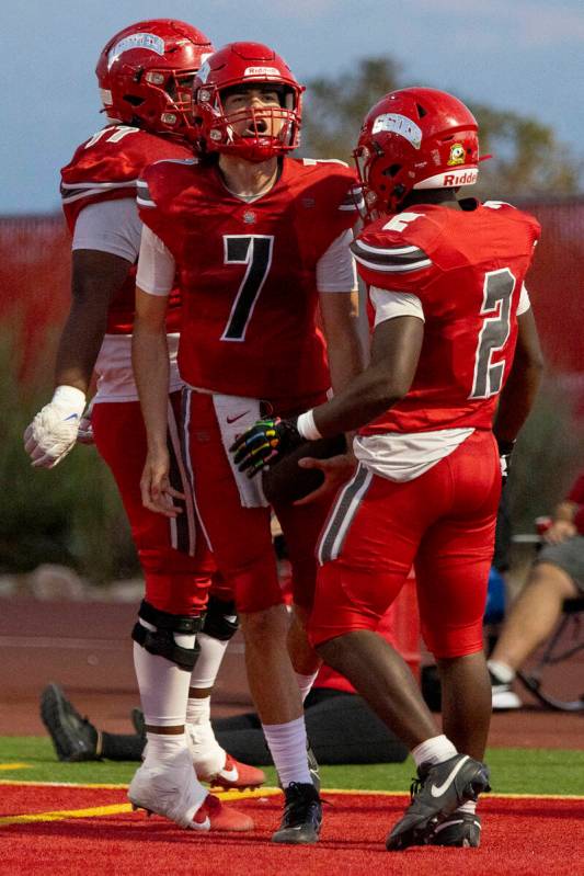 Arbor View quarterback Thaddeus Thatcher (7) celebrates with teammates after scoring a touchdow ...