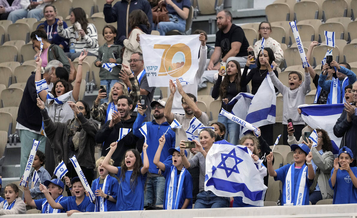 Survivors of the Kibbutz Nir Yitzak that was attacked by Hamas on October 7 hold banners which ...