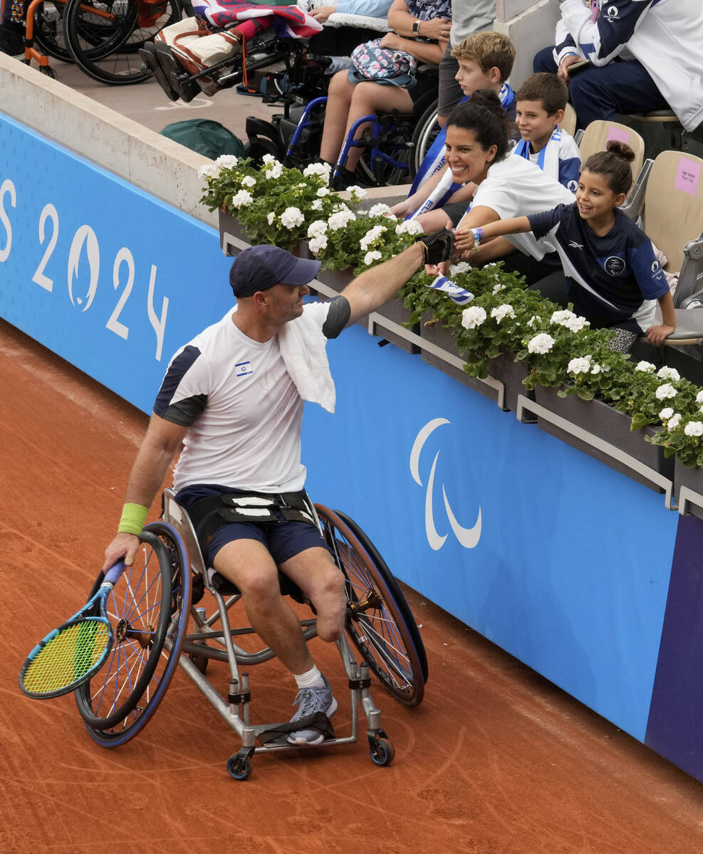 Israel's Adam Berdichevsky shakes hands with his wife Hila and his daughter during the 2024 Par ...