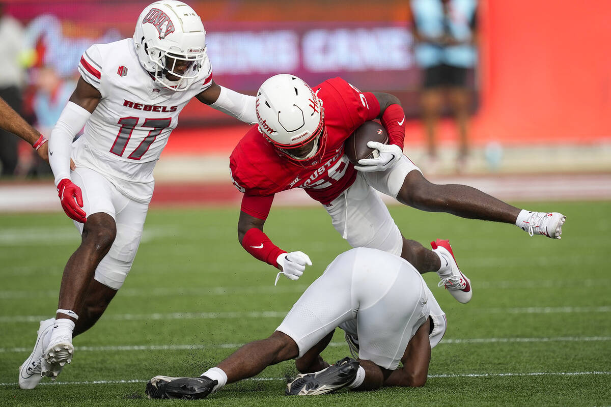 Houston defensive back Bryan Massey (22) returns a kick against UNLV during the first half of a ...