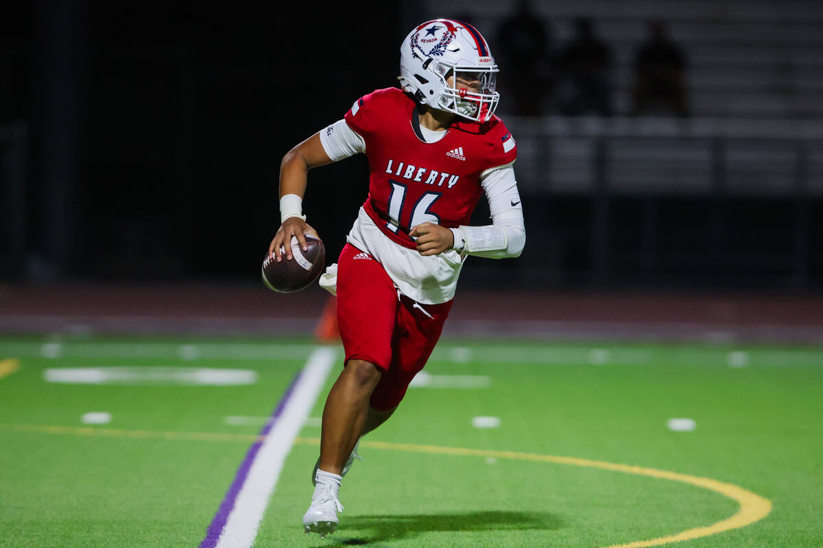 Liberty quarterback Troy Kan (16) pitches the ball during a Ninth Island Classic football game ...