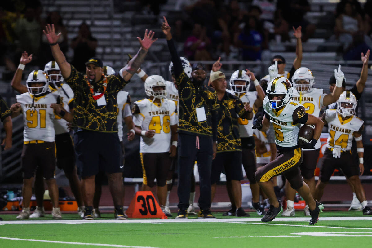 Mililani wide receiver Jonah Togafau-Tavui (5) runs the ball after a kick off during a Ninth Is ...