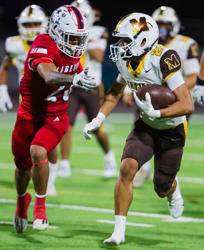 Mililani defensive back Darius Borges (20) runs the ball with one shoe missing during a Ninth I ...