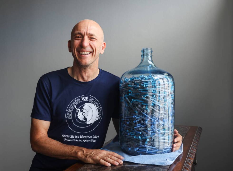 Derek Stefureac poses for a portrait with a container of syringes used for daily self-administe ...