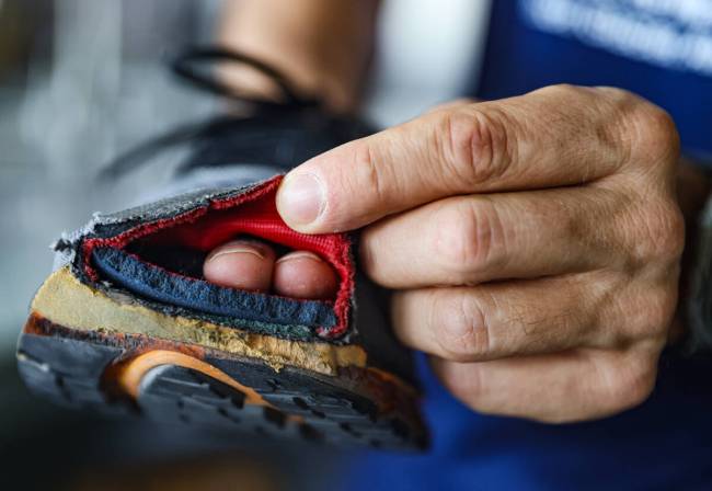 Derek Stefureac shows a running show with a hole in the toe from running with multiple sclerosi ...