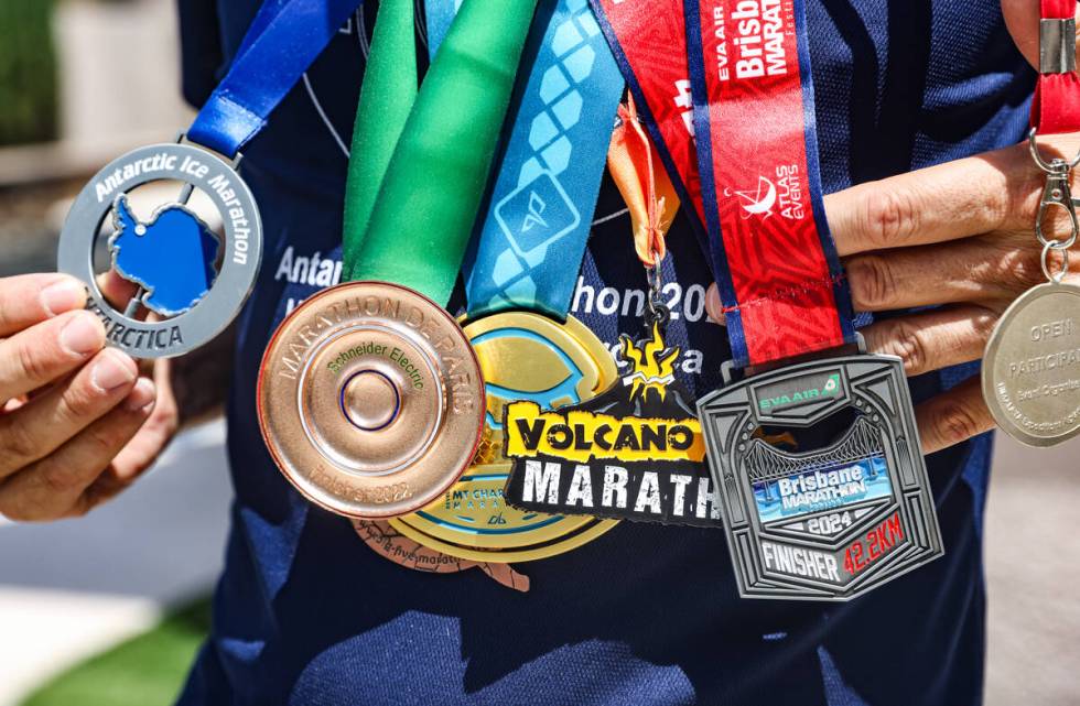 Derek Stefureac wears the medals he’s earned from marathons he ran on every continent at his ...