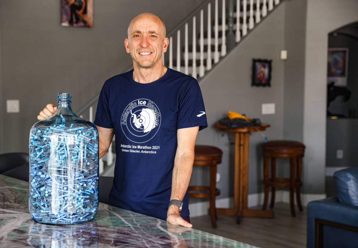 Derek Stefureac poses for a portrait with a container of syringes used for daily self-administe ...