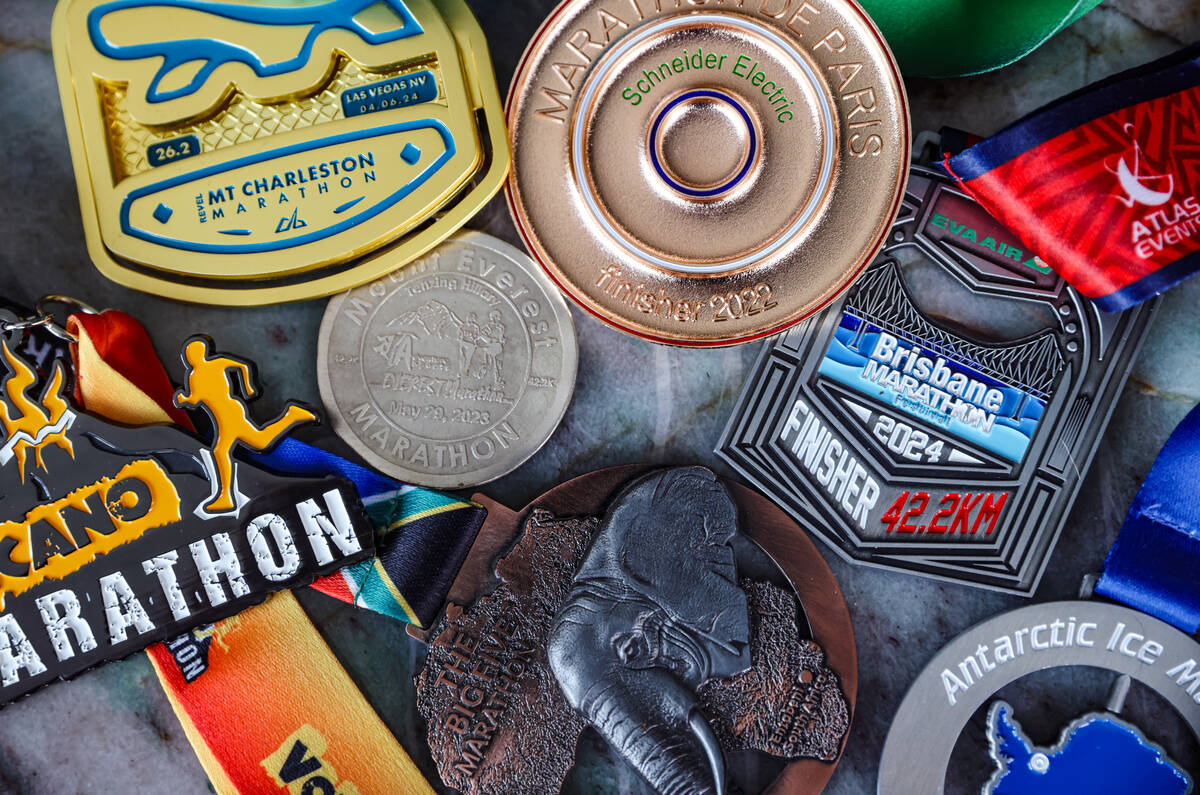 Derek Stefureac’s medals from marathons he has ran on every continent at his home in Las ...