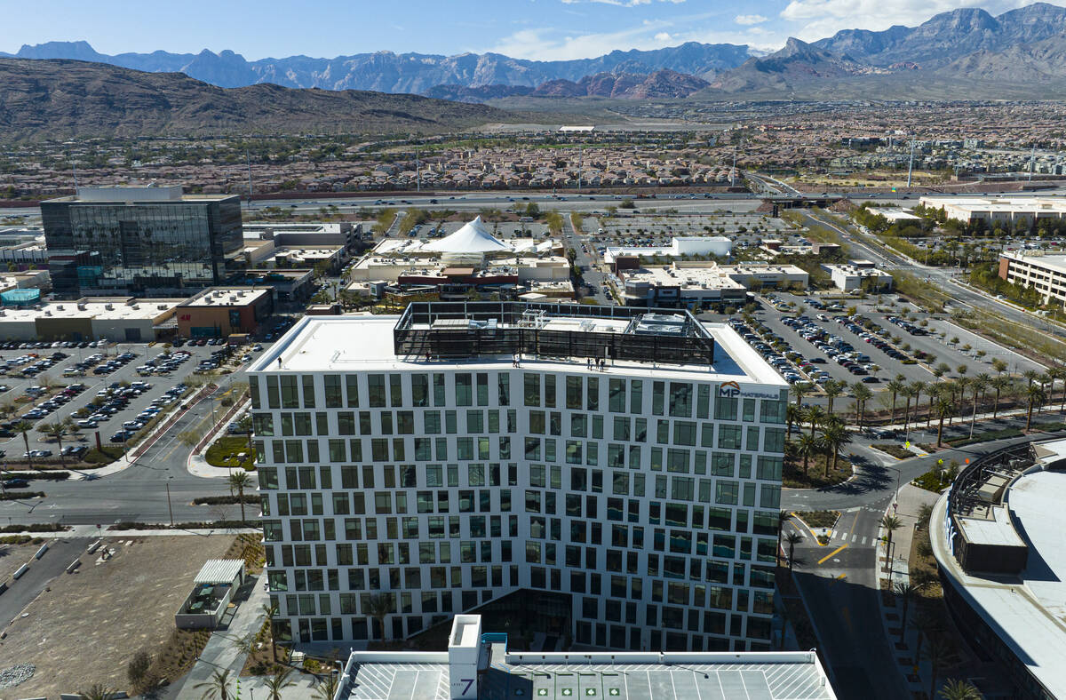 An aerial view of 1700 Pavilion, front, a ten-story office building, and One Summerlin, a 9-sto ...