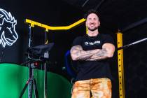 Troy Adashun, a local fitness influencer, poses for a portrait in his home gym in Henderson, Mo ...