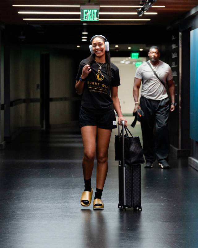 Aces star A'ja Wilson poses wearing a shirt that reps her and her mother's candle line, Burnt W ...