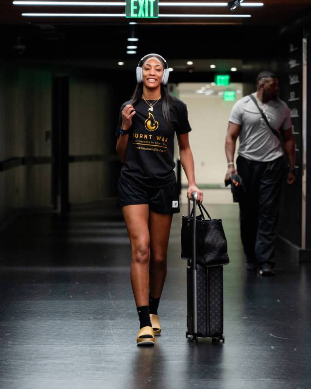 Aces star A'ja Wilson poses wearing a shirt that reps her and her mother's candle line, Burnt W ...