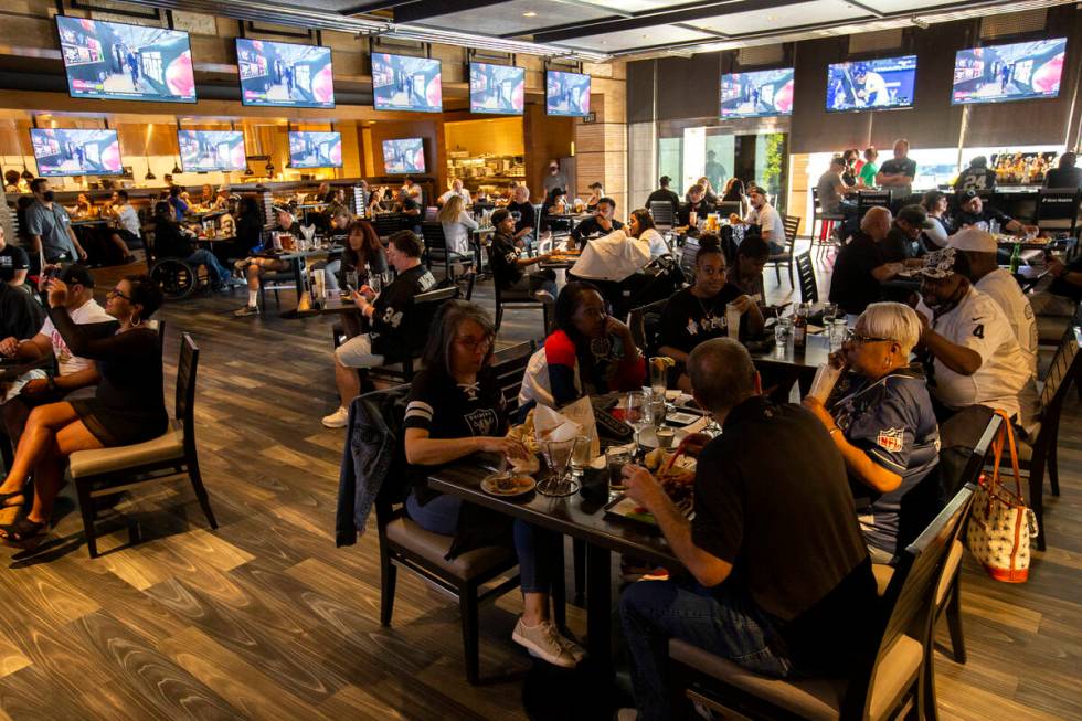 Raiders fans crowd the Raiders Tavern and Grill during the NFL Draft at M Resort on Thursday, A ...