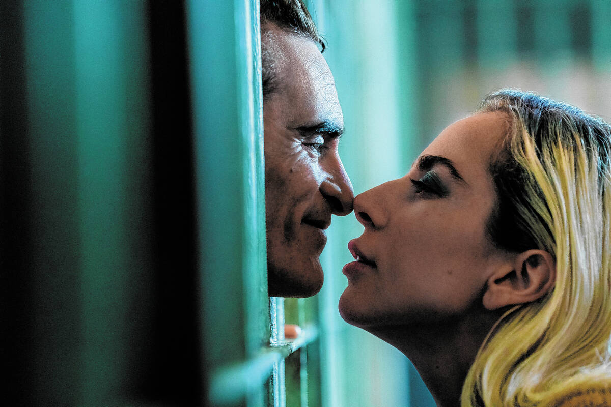 Caption: (L to r) JOAQUIN PHOENIX as Arthur Fleck and LADY GAGA as Lee Quinzel in Warner Bros. ...