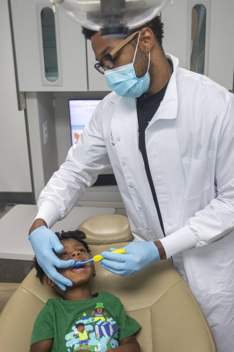 Sammy Hale, 4, has his teeth cleaned by dentist Terry Meads at Changing Smiles Pediatric Dentis ...