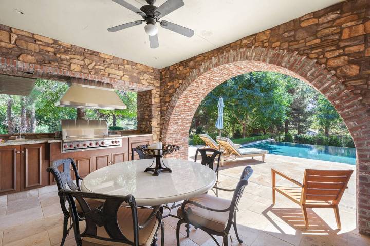 Outdoor kitchens come in a variety of designs. This one features a covered patio, poolside. (IS ...