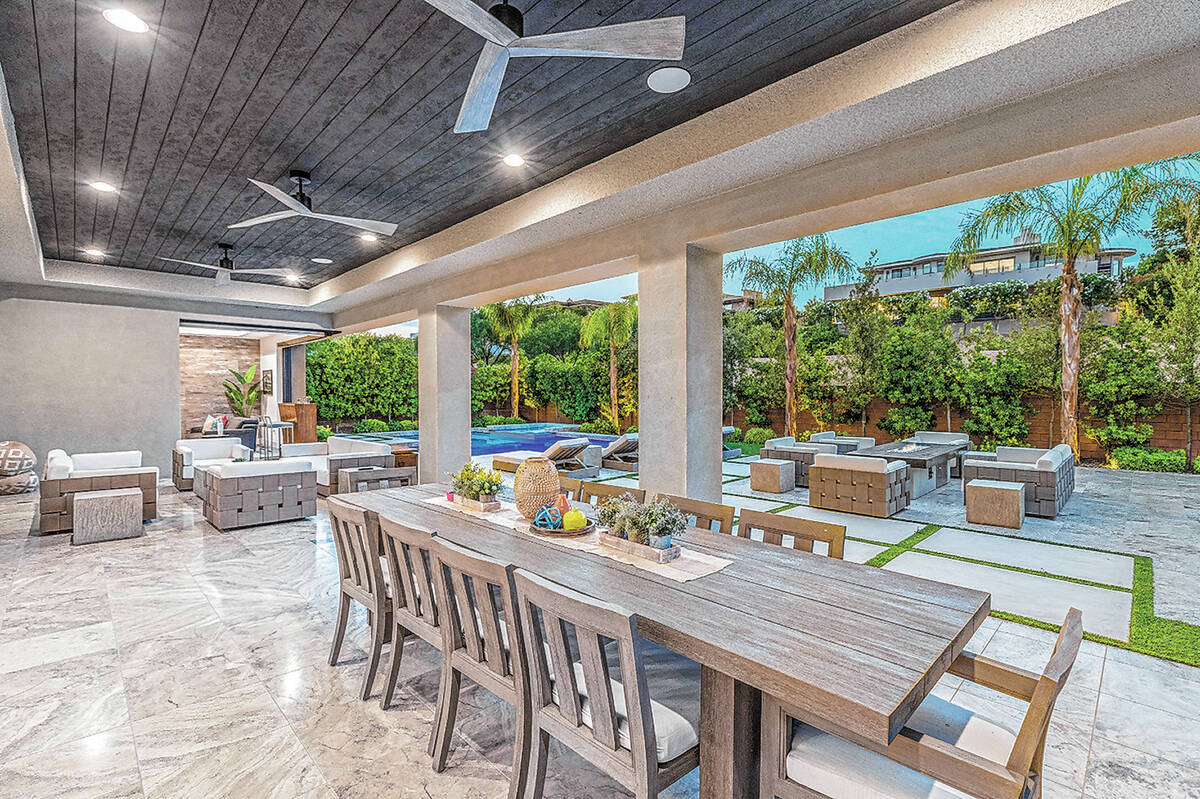 Oversized pocket doors open to a covered patio and pool deck for seamless indoor and outdoor li ...