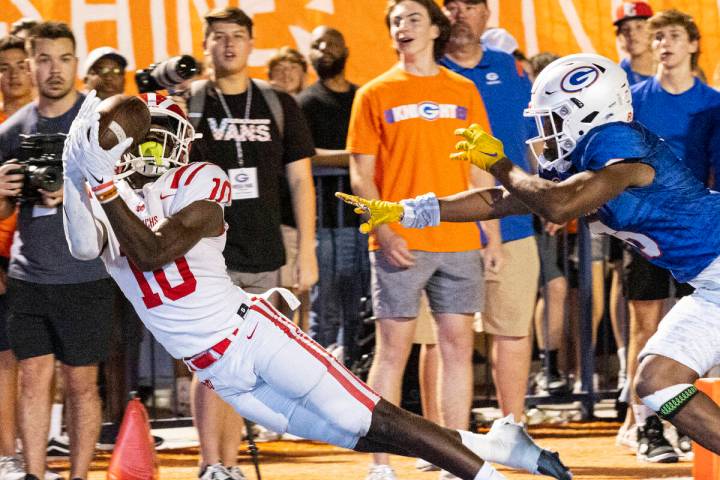 Mater Dei's wide receiver Marcus Harris (10) dives to catch a touchdown pass as Bishop Gorman's ...