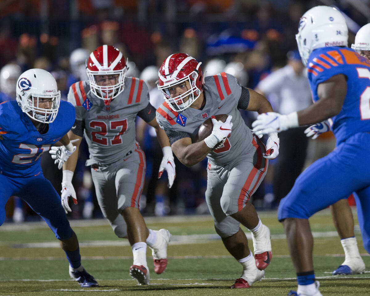 Mater Dei senior running back Glenn Harper (3) breaks off a big run past Bishop Gorman junior d ...