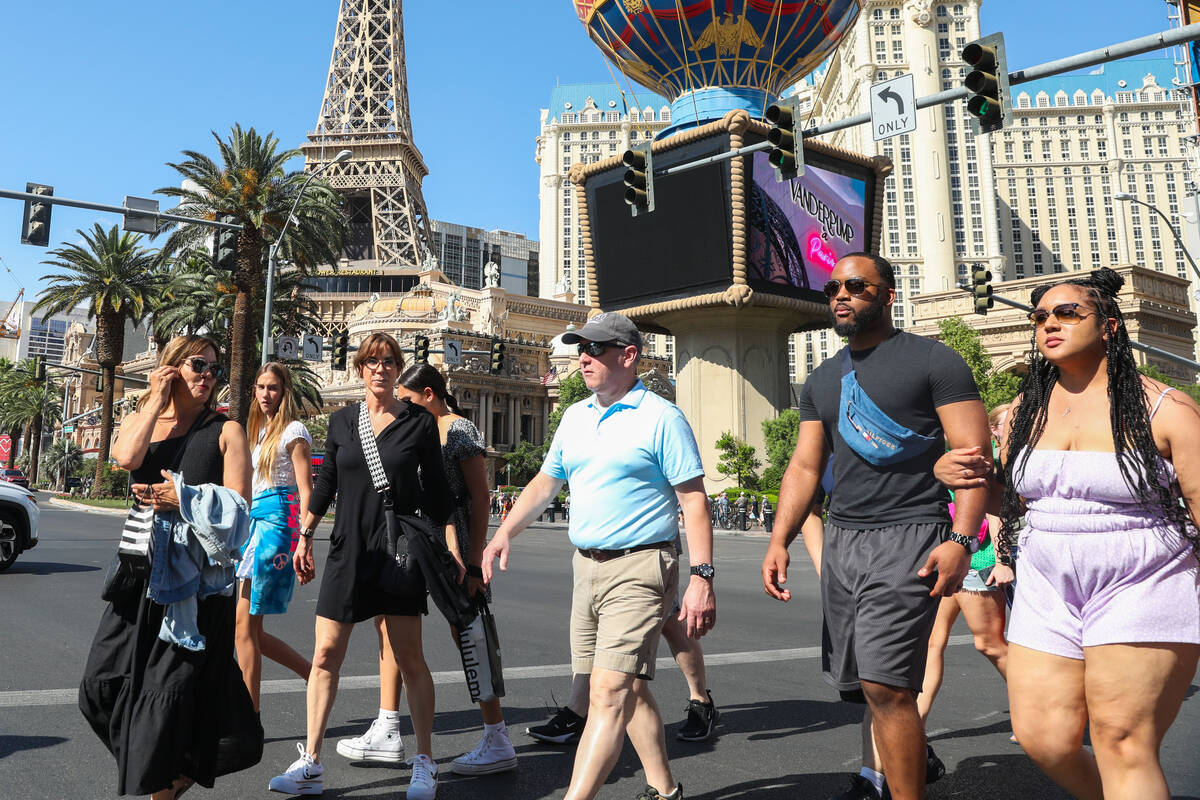 Crowds of tourists brave the heat as they walk along the Strip on Thursday, June 29, 2023, in L ...