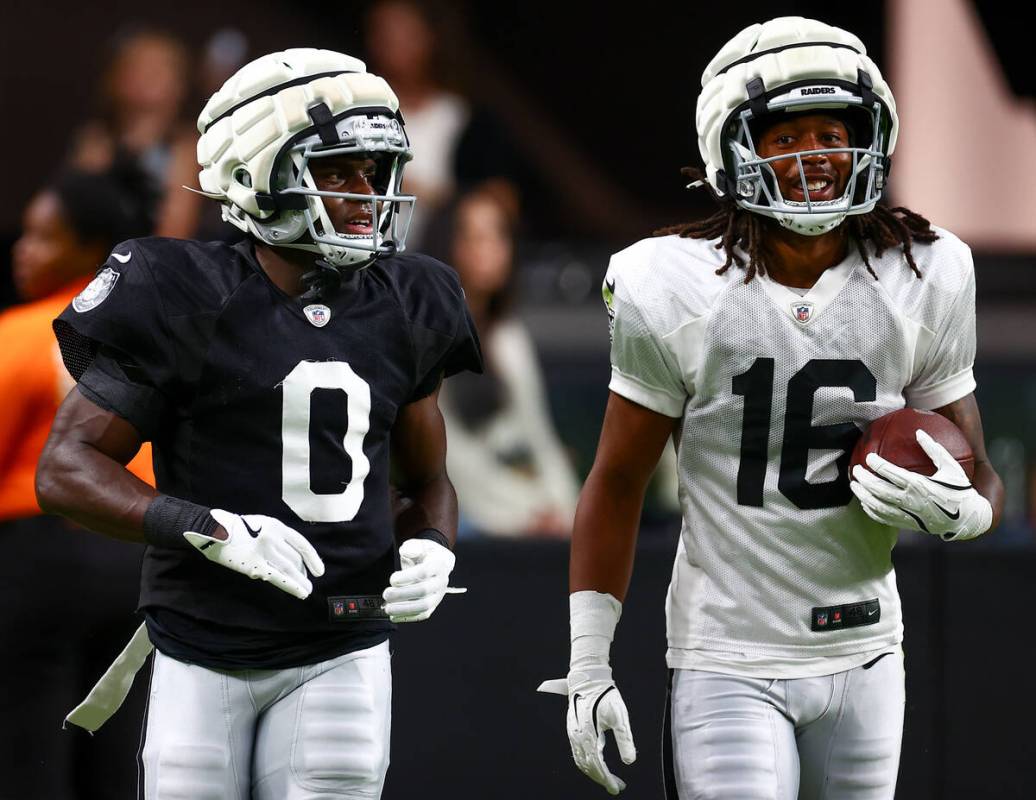 Raiders cornerback Jakorian Bennett (0) and wide receiver Jakobi Meyers (16) walk up the field ...