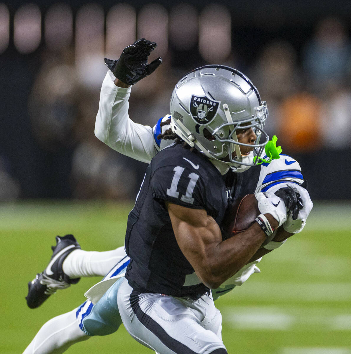 Raiders wide receiver Tre Tucker (11) looks in a long pass over Dallas Cowboys cornerback Andre ...