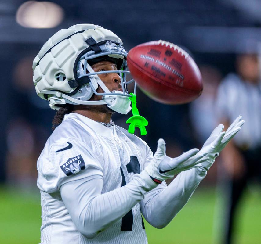 Raiders wide receiver Tre Tucker (11) reaches out for a punt return during an open practice at ...