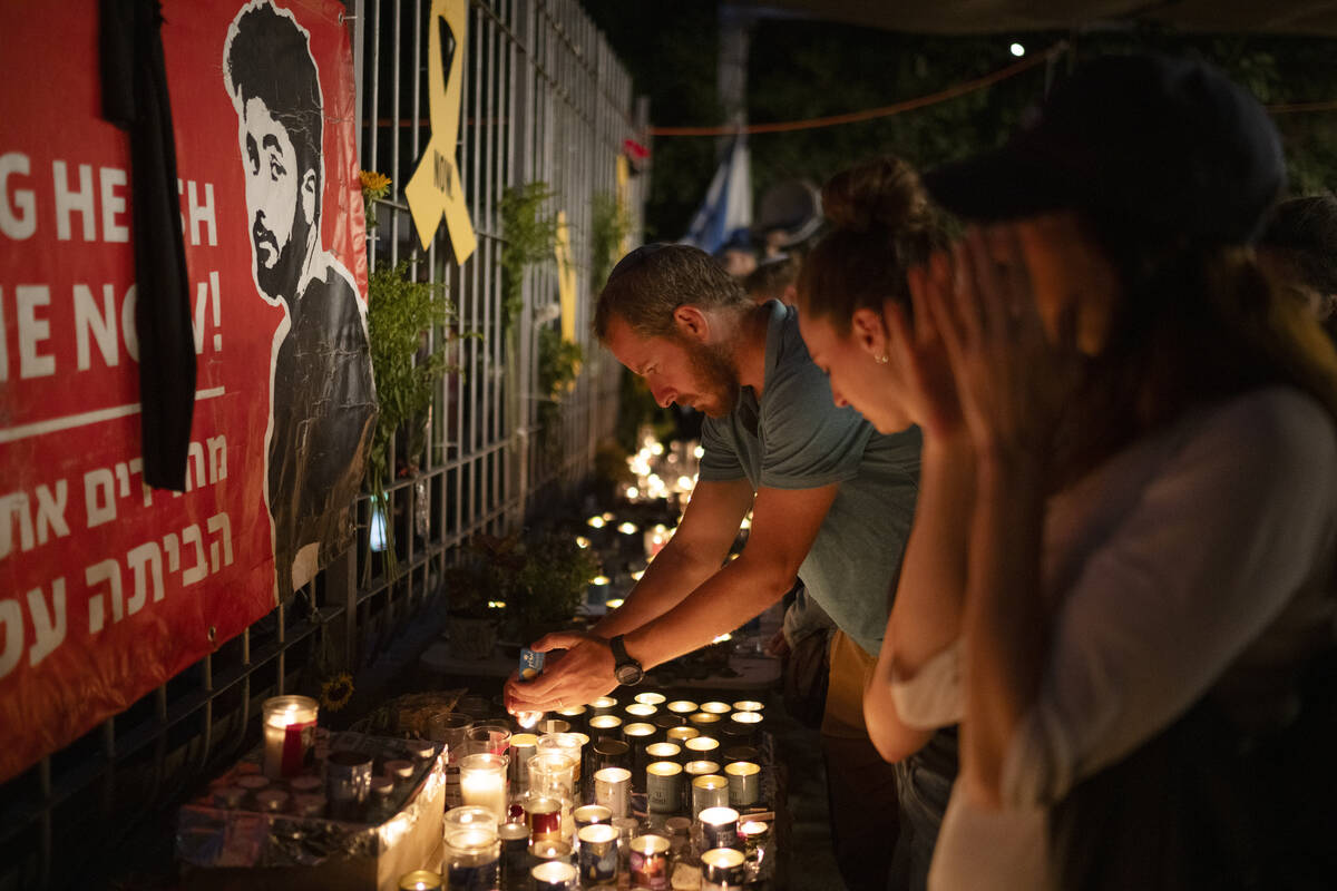 People light candles during a vigil in memory of slain hostage Hersh Goldberg-Polin in Jerusale ...