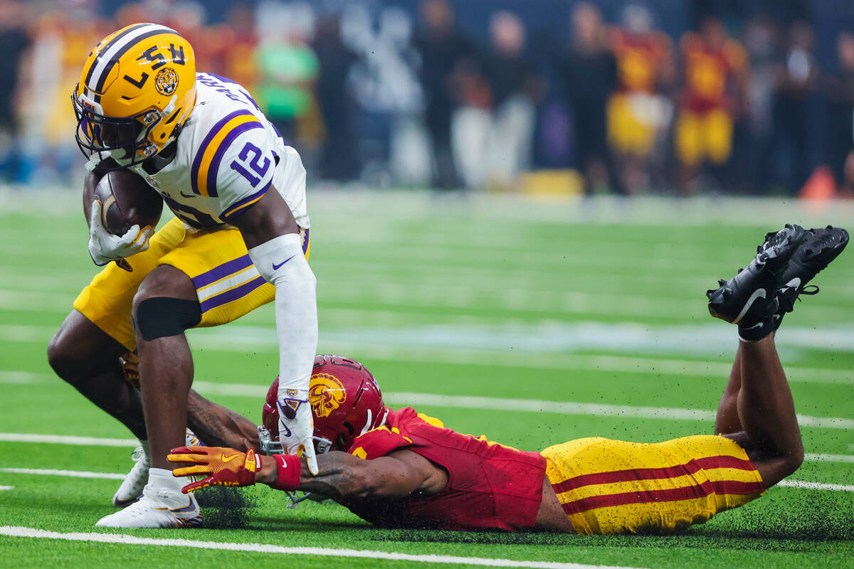 Southern California cornerback Jaylin Smith (2) grabs LSU wide receiver Kyle Parker (12) as he ...