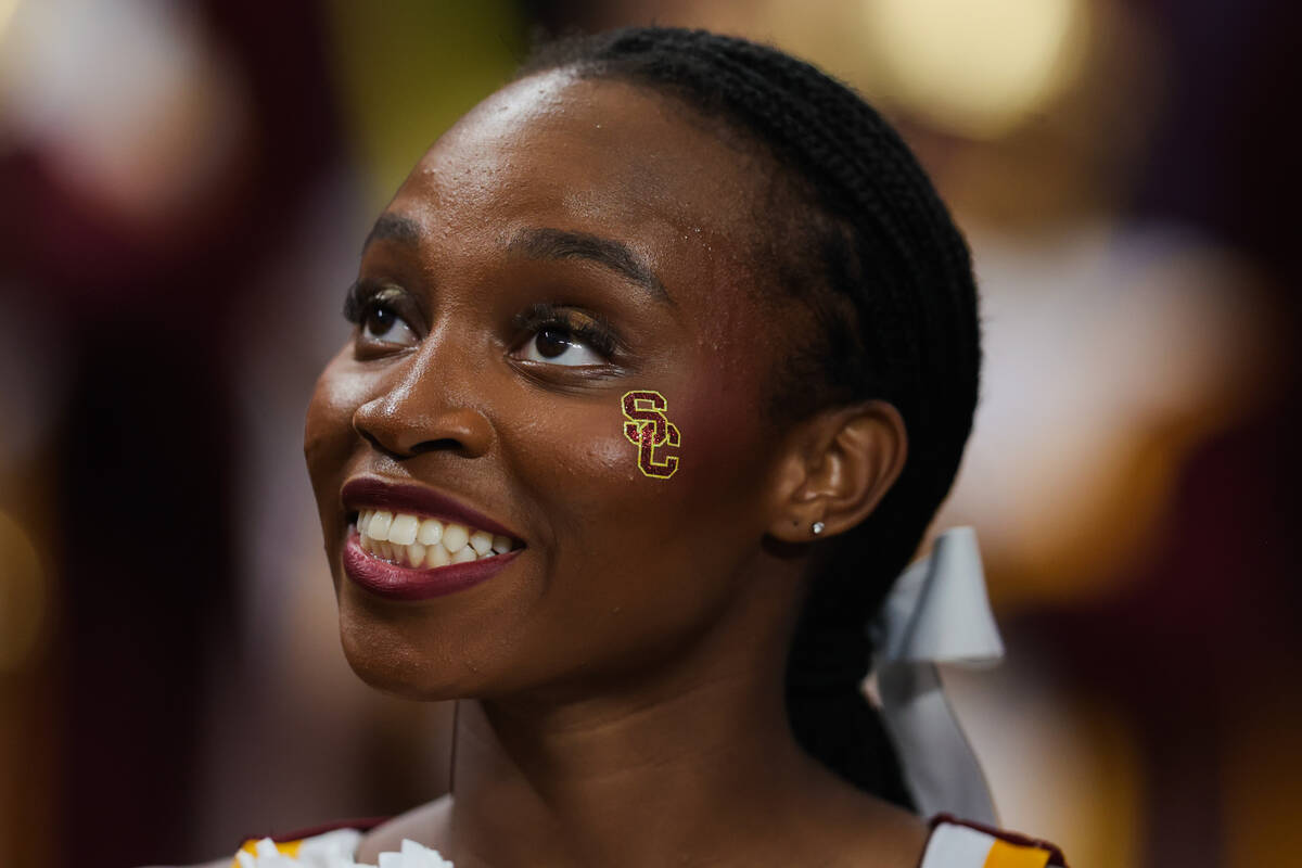 A Southern California cheerleader smiles during the Vegas Kickoff Classic NCAA football game be ...