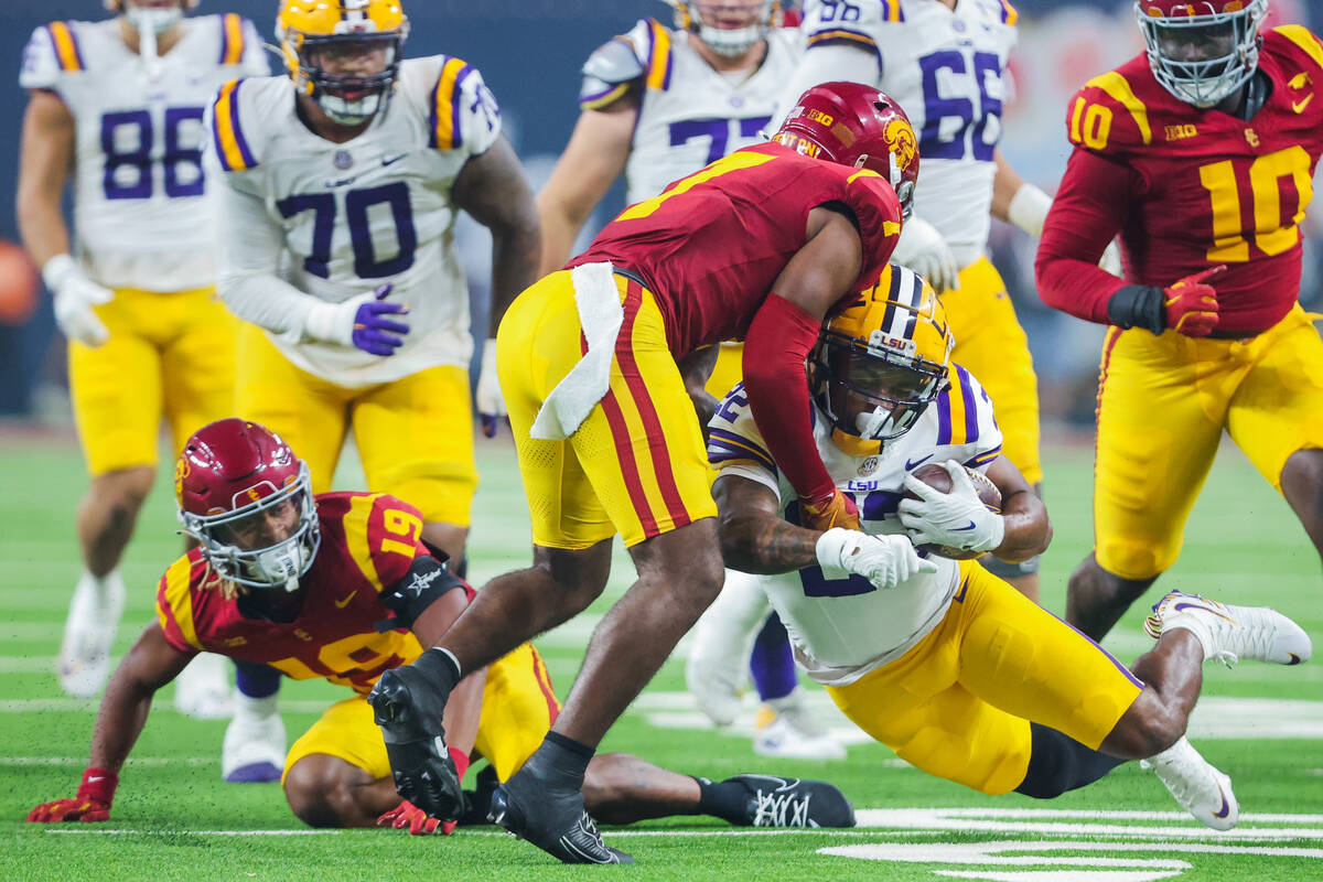 LSU running back John Emery Jr. (22) breaks out of Southern California defense to carry the bal ...