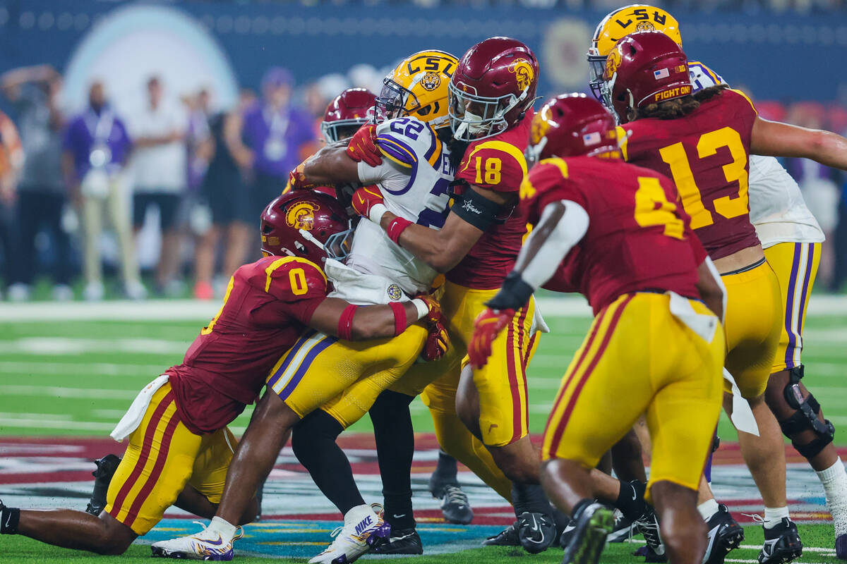 LSU running back John Emery Jr. (22) struggles to carry the ball through Southern California de ...