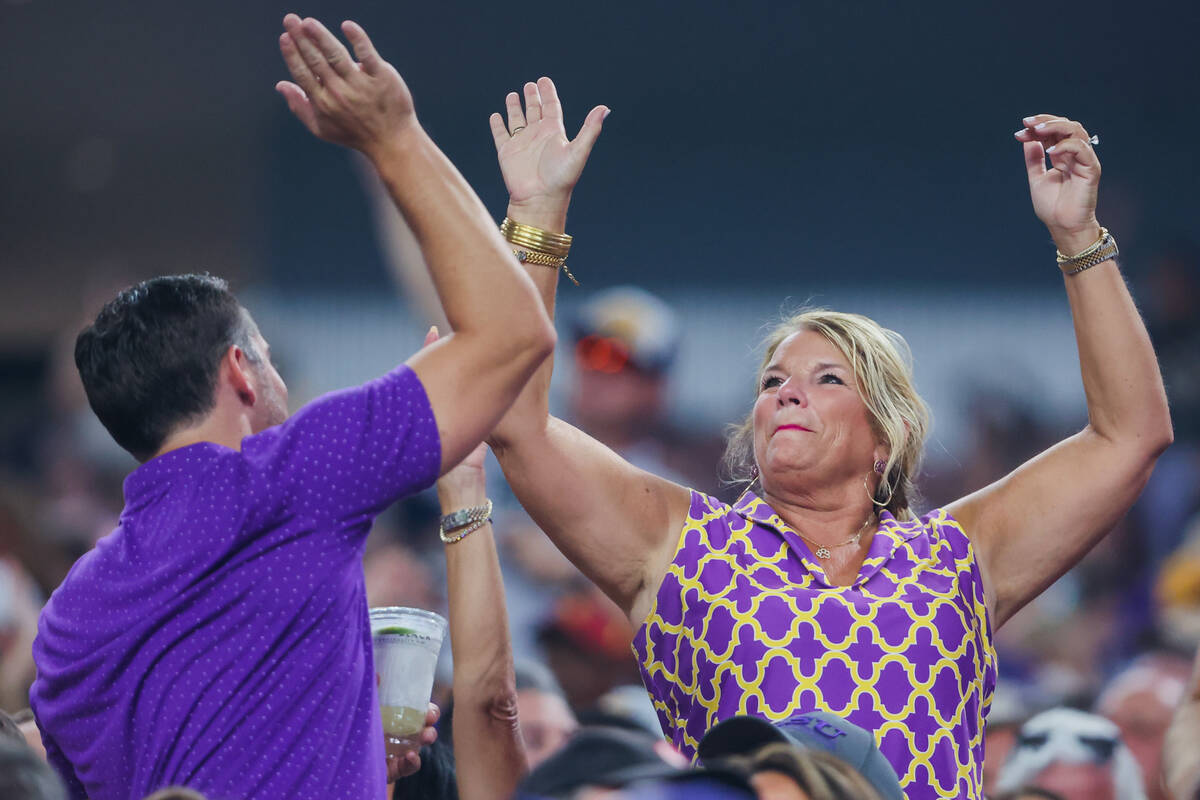 LSU fans high five during the Vegas Kickoff Classic NCAA football game between LSU and Southern ...